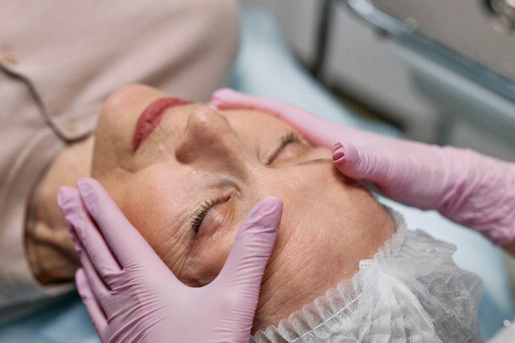 A serene spa therapy session with a senior woman enjoying a facial massage for rejuvenation.